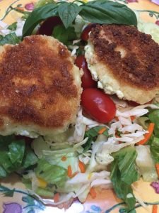 Baked goat cheese medallions on a crisp salad